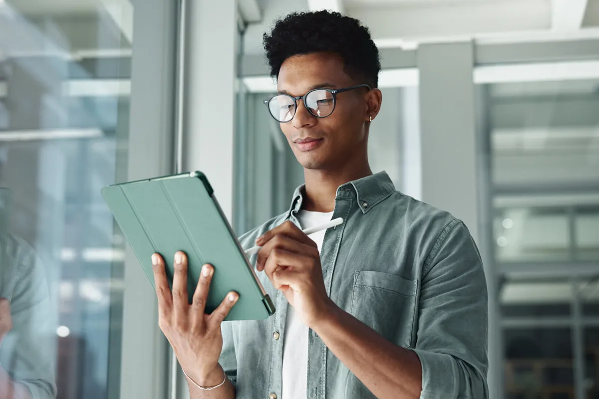 A guy writing on a tablet