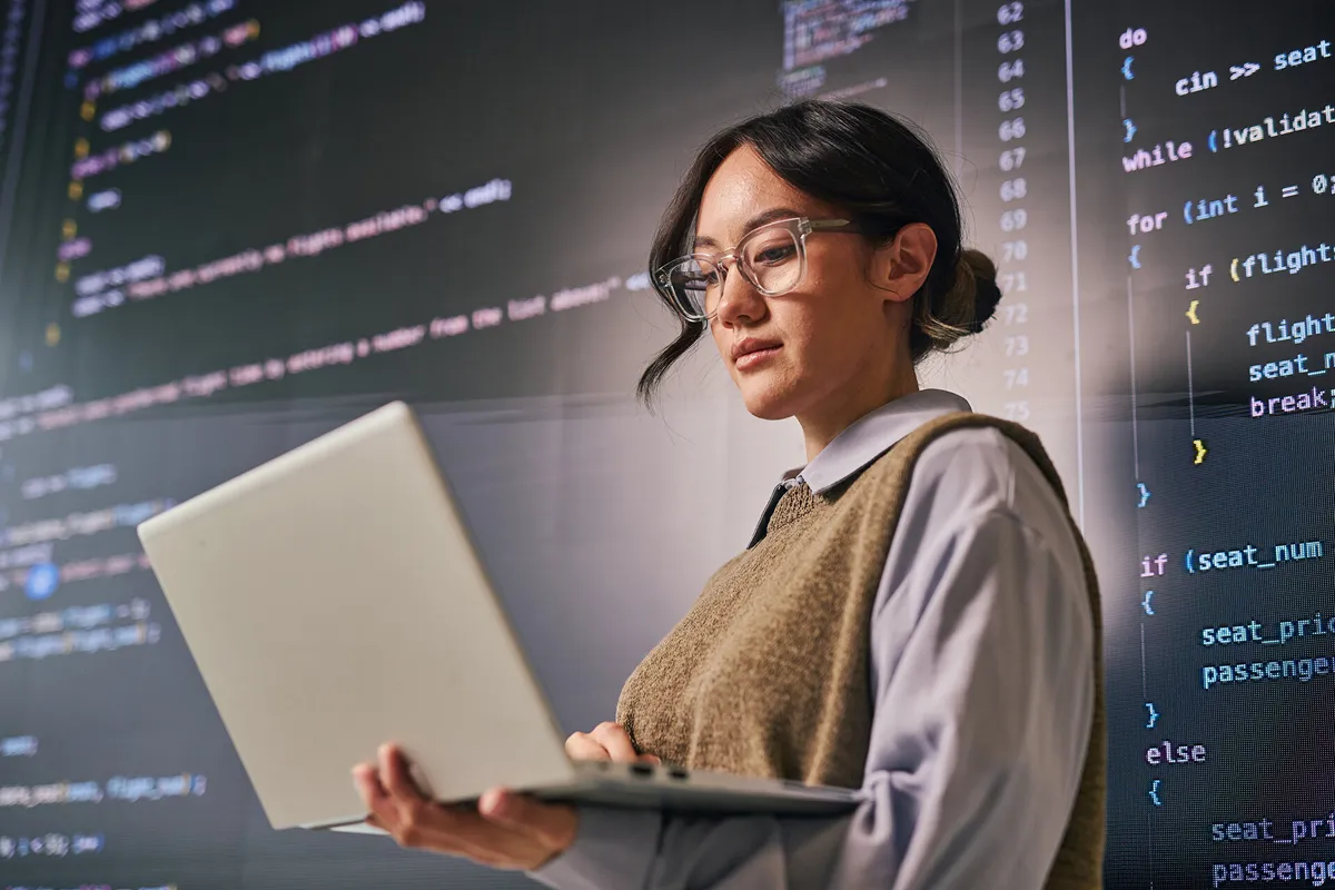 a woman writing on a laptop
