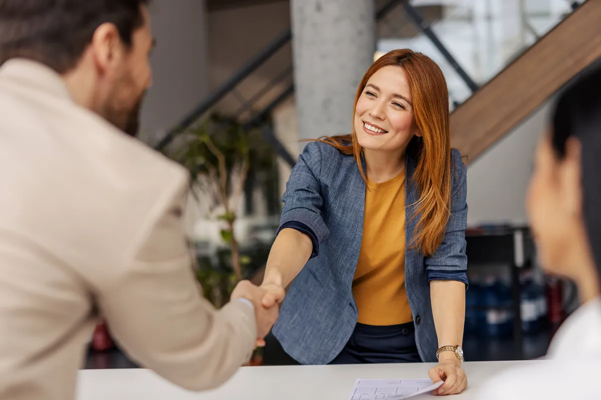 a woman shaking a hand of a man